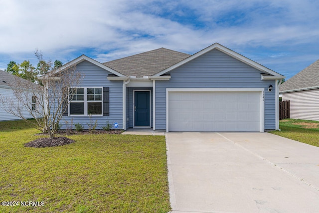 ranch-style house featuring a front yard and a garage