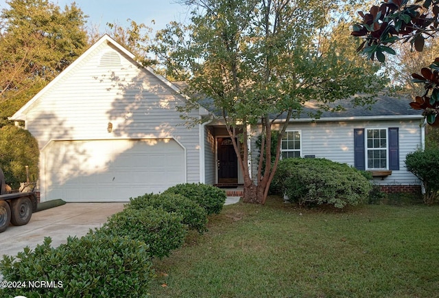 ranch-style house featuring a front yard and a garage