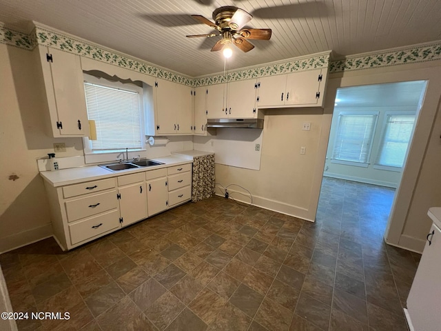 kitchen featuring ornamental molding, sink, ceiling fan, and white cabinets