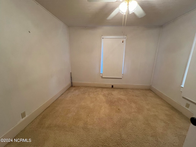 carpeted empty room featuring ceiling fan