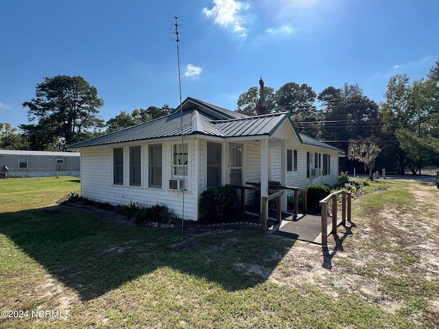 view of side of home featuring a lawn