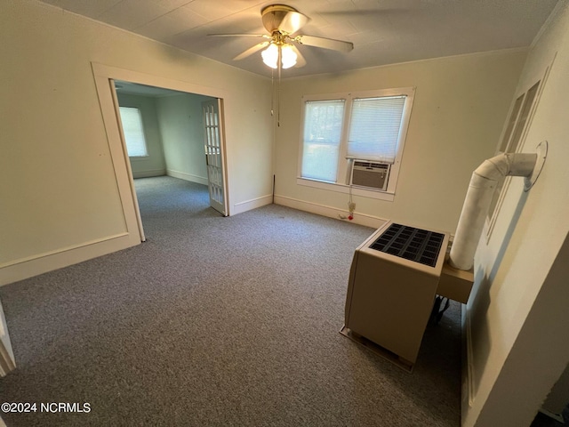 empty room with cooling unit, ceiling fan, carpet floors, and heating unit