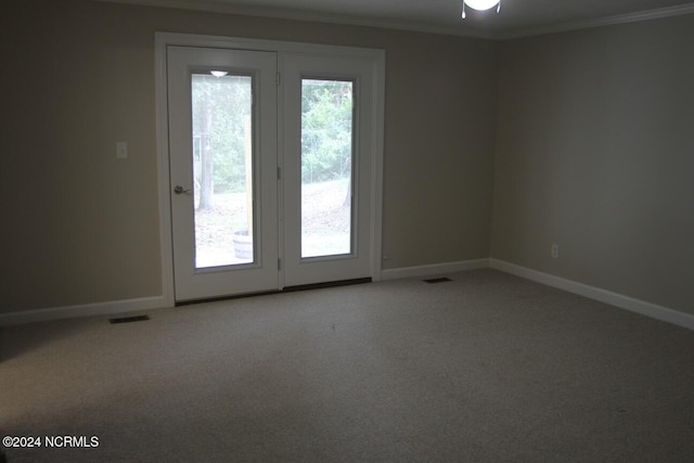 carpeted empty room with ceiling fan and ornamental molding