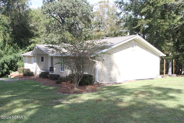 view of home's exterior with a yard