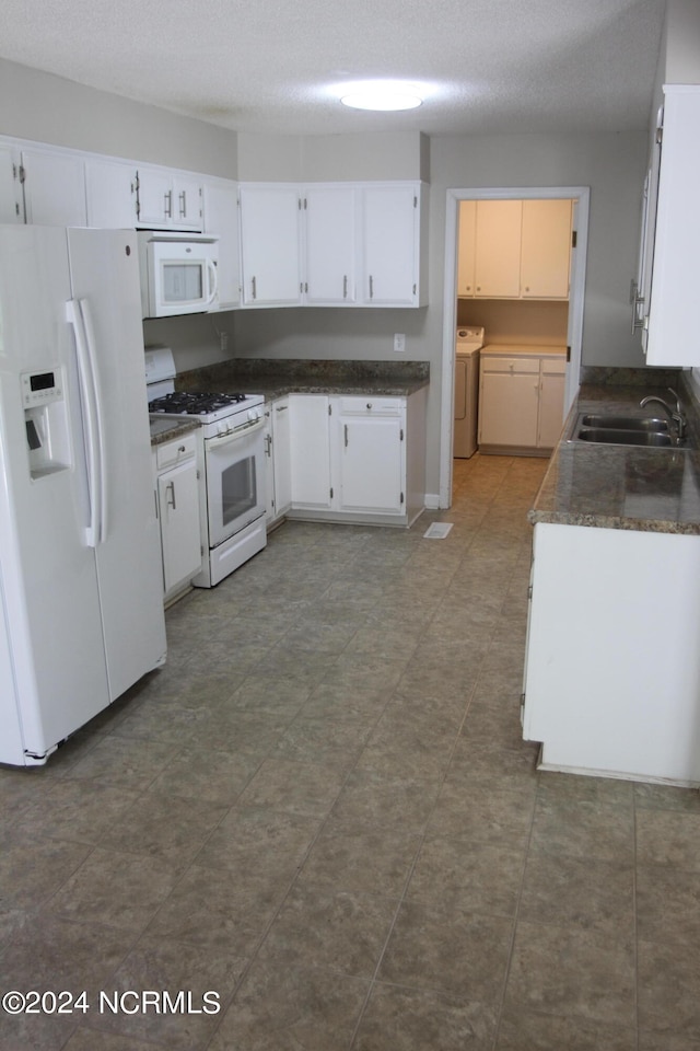 kitchen with white cabinets, sink, white appliances, and a textured ceiling