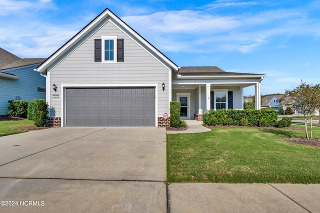 view of front of property with a garage and a front yard