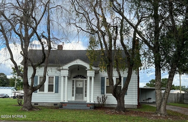 view of front facade with a front yard and a carport