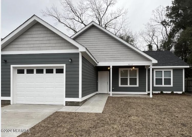 view of front of house with a porch and a garage