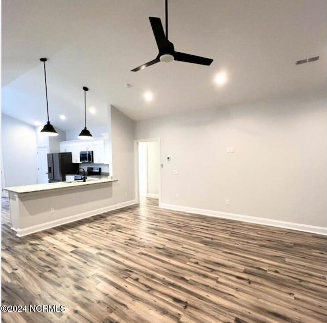 unfurnished living room with vaulted ceiling, ceiling fan, and hardwood / wood-style flooring