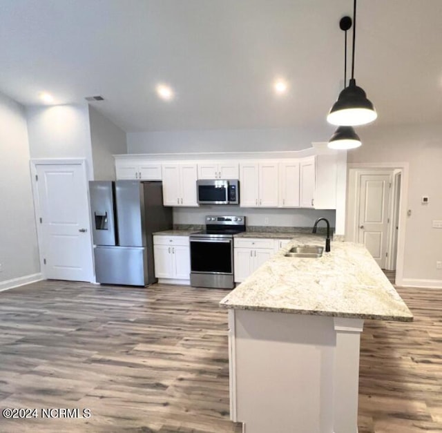 kitchen featuring hanging light fixtures, white cabinetry, sink, and stainless steel appliances