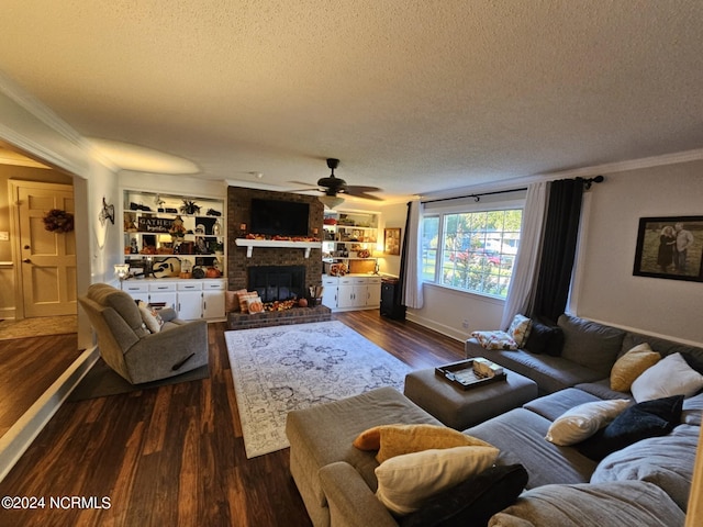 living room featuring built in shelves, ceiling fan, a textured ceiling, crown molding, and dark hardwood / wood-style flooring