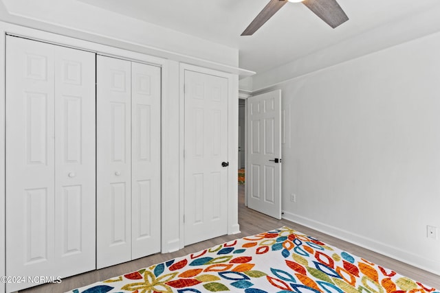 bedroom with ceiling fan and light hardwood / wood-style floors