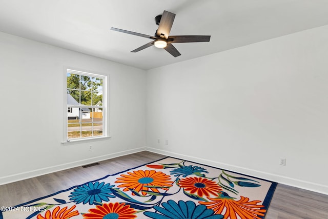 empty room featuring hardwood / wood-style flooring and ceiling fan