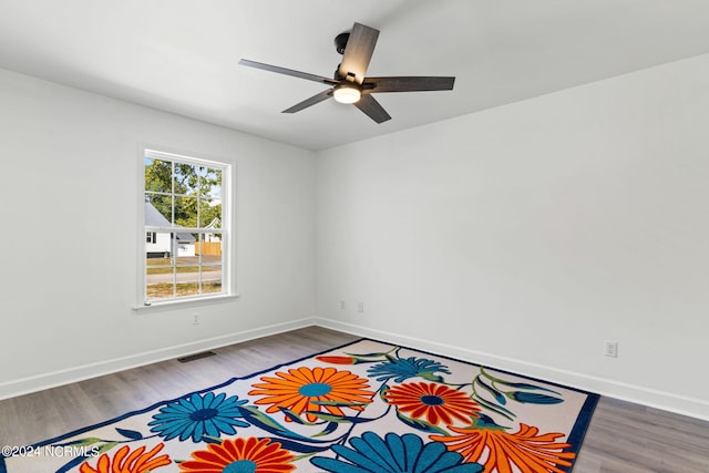 160 NE 5th St, Oak Island, NC 28465 - spare room featuring ceiling fan, wood finished floors, and baseboards