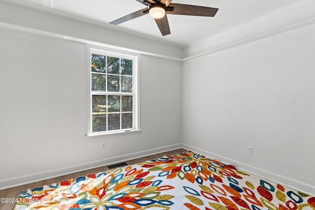 spare room with hardwood / wood-style flooring and ceiling fan