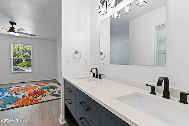 bathroom featuring hardwood / wood-style floors, vanity, and ceiling fan