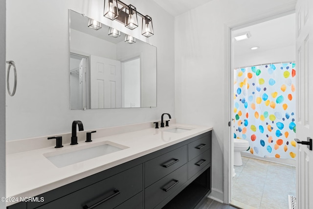 bathroom featuring tile patterned floors, vanity, and toilet