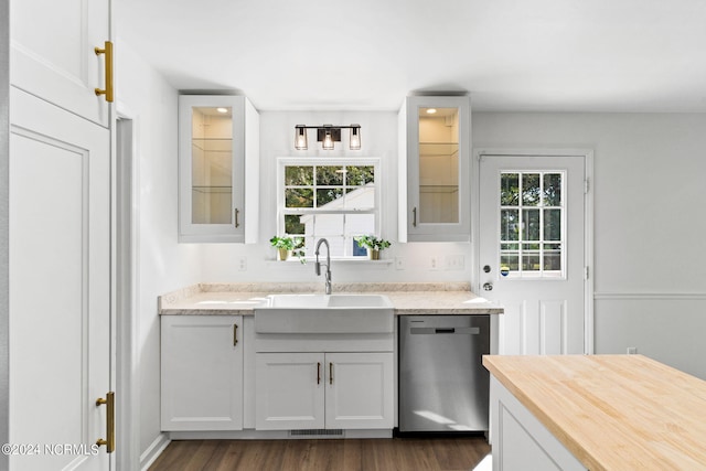 kitchen with dishwasher, dark hardwood / wood-style floors, white cabinetry, and sink