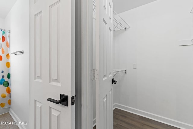 walk in closet featuring dark wood-type flooring