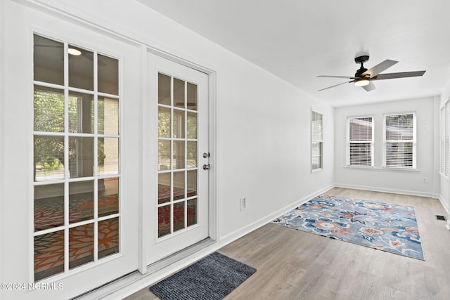 doorway to outside with hardwood / wood-style flooring and ceiling fan