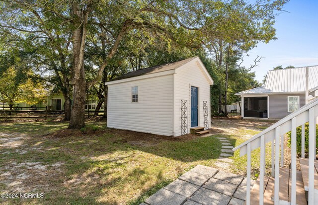 view of outdoor structure with a lawn