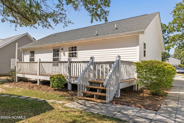 back of property featuring a wooden deck