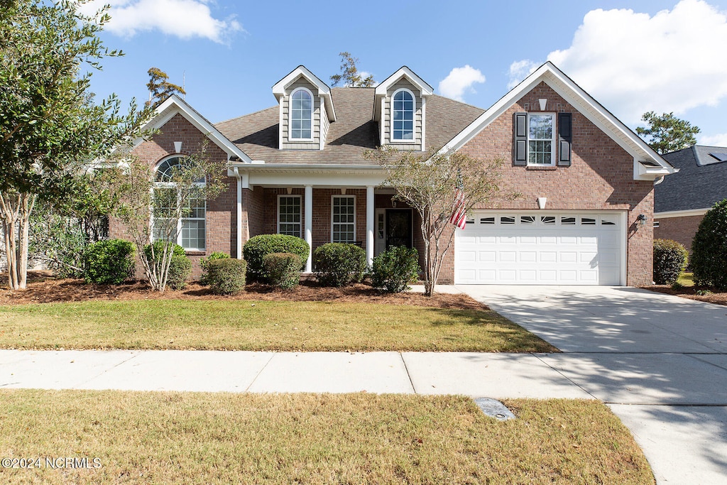 view of front of home with a front lawn and a garage