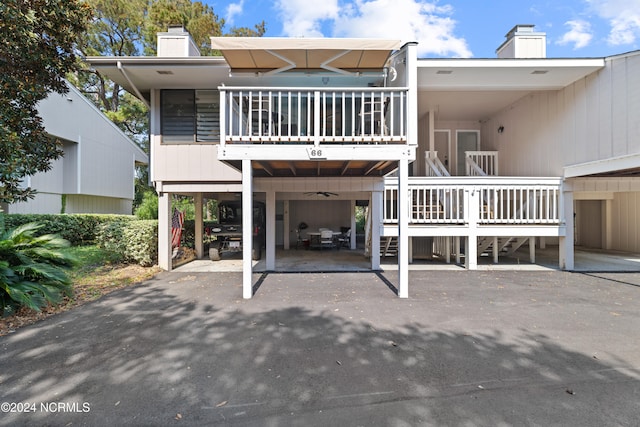 back of property with a carport