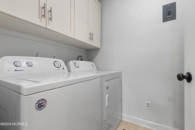 clothes washing area with cabinets, light tile patterned floors, and washing machine and dryer