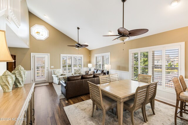 dining room featuring dark hardwood / wood-style floors, ceiling fan, and high vaulted ceiling