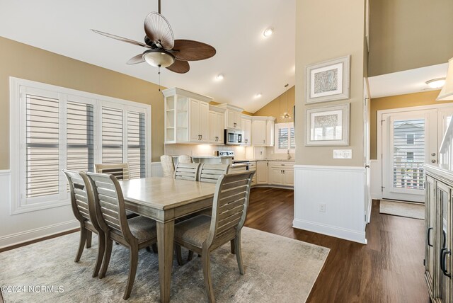 kitchen with dark hardwood / wood-style flooring, stainless steel appliances, sink, pendant lighting, and white cabinets