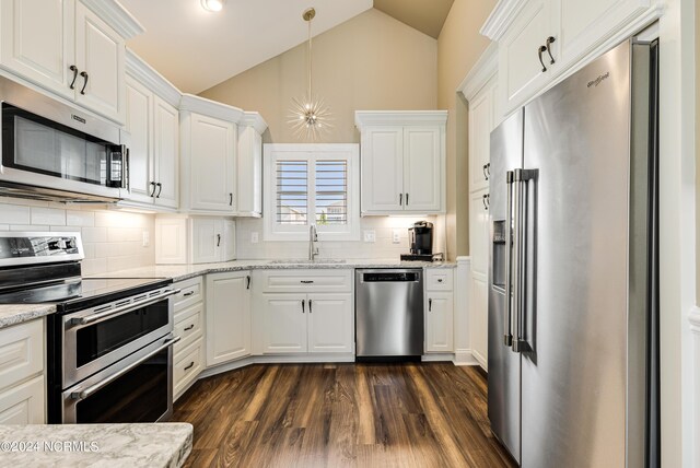 kitchen featuring stainless steel appliances, white cabinetry, a wealth of natural light, and dark wood-type flooring