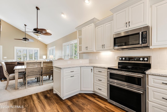 kitchen with a healthy amount of sunlight, appliances with stainless steel finishes, white cabinetry, and dark wood-type flooring