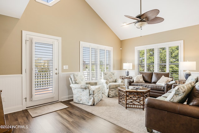 living room featuring dark hardwood / wood-style floors, high vaulted ceiling, and ceiling fan