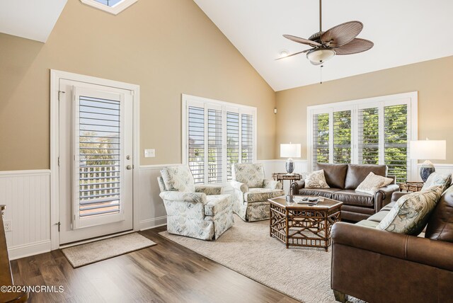 living room featuring ceiling fan, high vaulted ceiling, and wood-type flooring