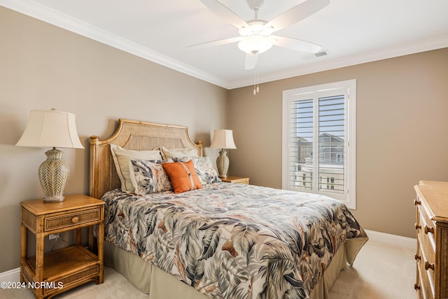 bedroom with visible vents, light colored carpet, crown molding, and baseboards