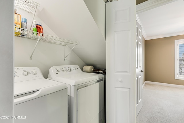 laundry room featuring baseboards, laundry area, ornamental molding, light carpet, and washing machine and dryer