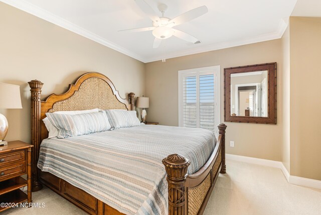 carpeted bedroom with ensuite bath, ceiling fan, and ornamental molding