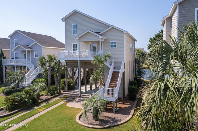 raised beach house featuring a front yard