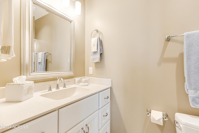 bathroom featuring vanity and toilet