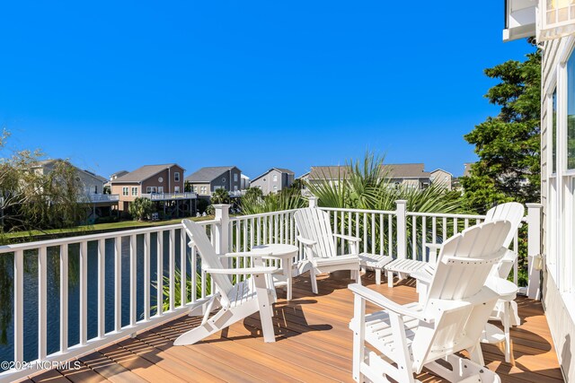 wooden deck featuring a water view