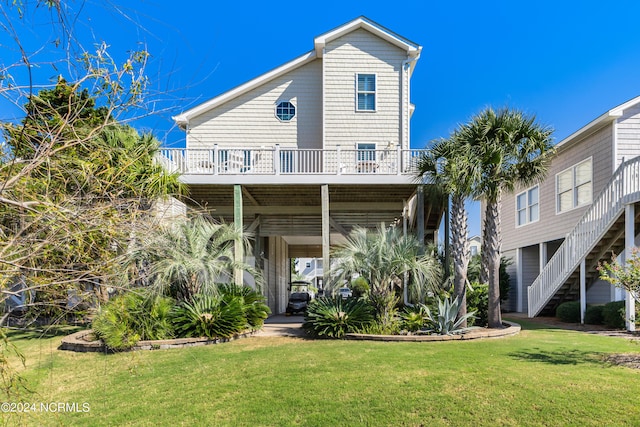 rear view of property with a lawn