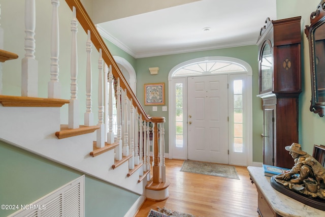 foyer featuring light hardwood / wood-style floors and ornamental molding