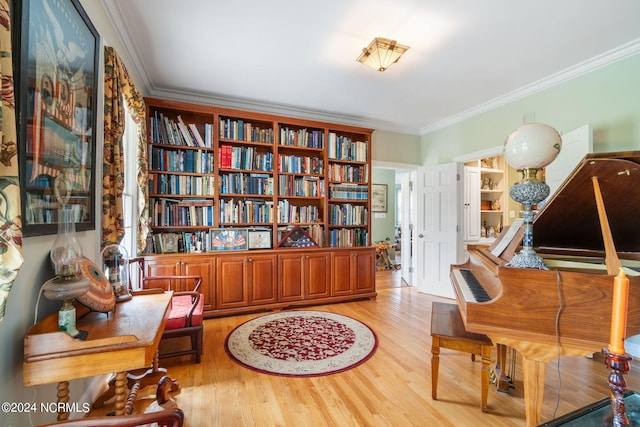 living area with light wood-type flooring and crown molding