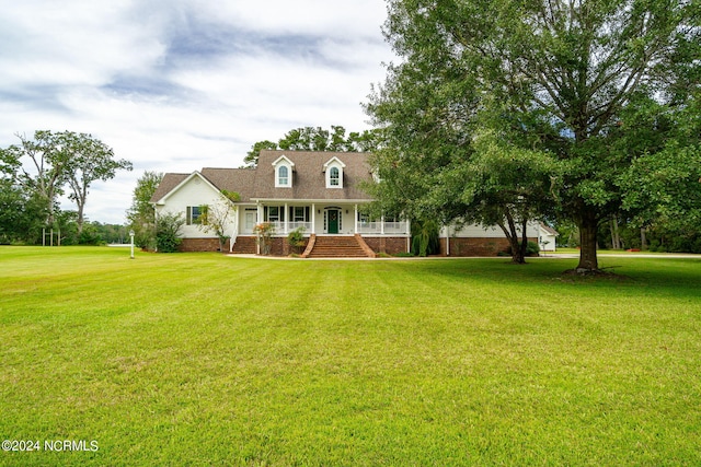 cape cod home featuring covered porch and a front yard