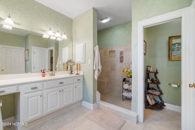 bathroom featuring tile patterned floors, vanity, and tiled shower