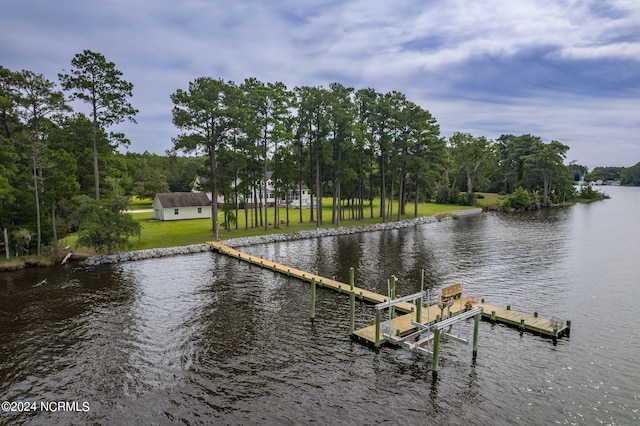 dock area featuring a water view and a lawn