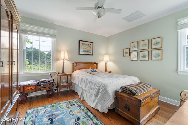 bedroom with dark hardwood / wood-style floors, ceiling fan, and crown molding