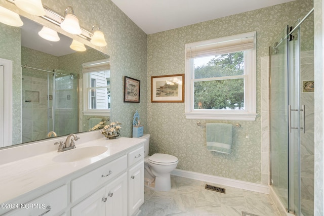 bathroom featuring vanity, toilet, and a shower with door