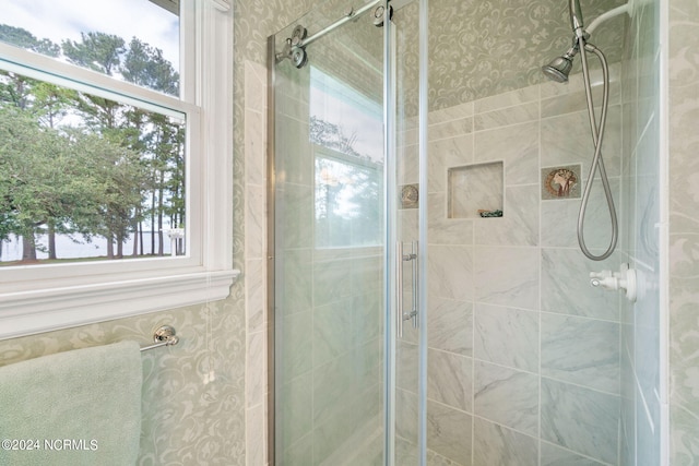 bathroom featuring a healthy amount of sunlight and walk in shower